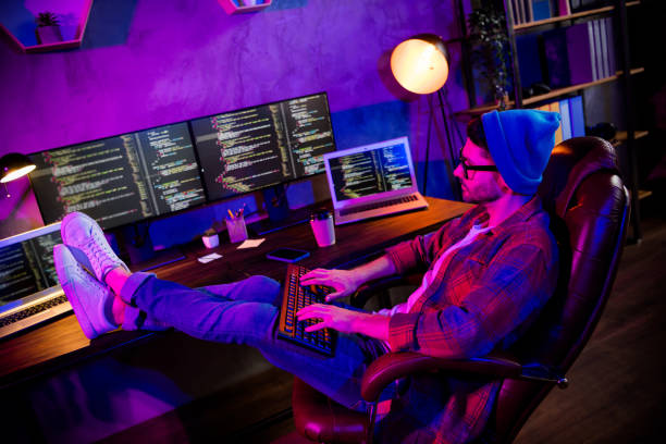 istock Photo of happy smiling programmer wear spectacles hat coding keyboard website indoors workplace workshop home 2174808507
