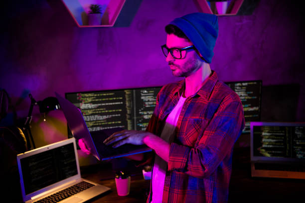istock Photo of ponder pensive guy dressed glasses hat writing safety code modern device indoors workstation workshop home 2174809277