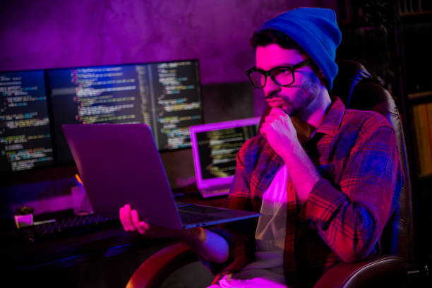 istock Photo of thoughtful minded programmer wear spectacles thinking reading modern device indoors workplace workshop home 2174809287