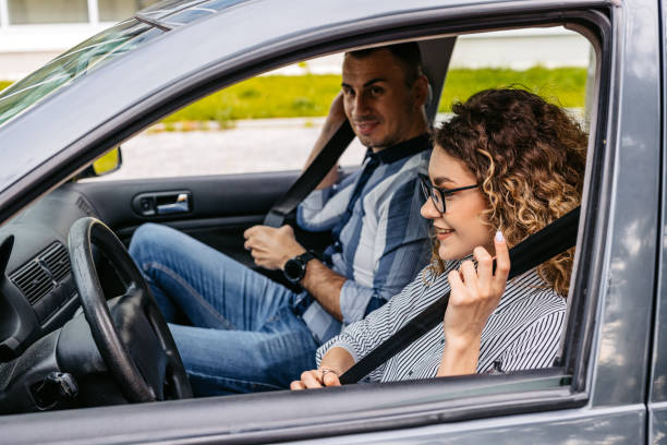 istock Driving Instructor And A Female Student Fastening Their Seatbelts 2174811561