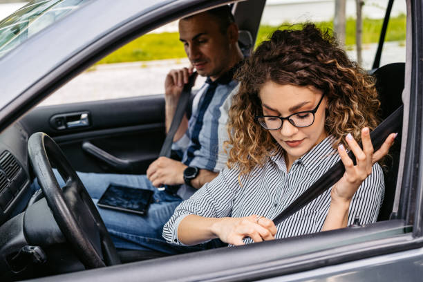 istock Driving Instructor And A Female Student Fastening Their Seatbelts 2174811889