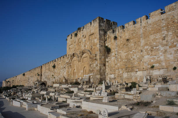 The outer walls of the Old City and Jerusalem and the sealed Mercy Gate and twin arches. stock photo