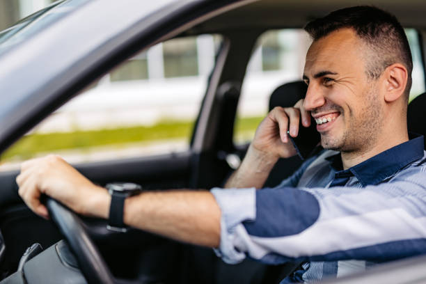 istock Mid-Adult Man Talking On The Phone While Driving A Car 2174813236