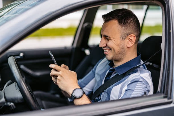 istock Mid-Adult Man Using His Phone While Driving A Car 2174815474