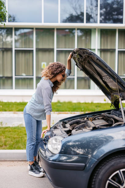 istock Young Woman Having Car Problems On The Street 2174815753