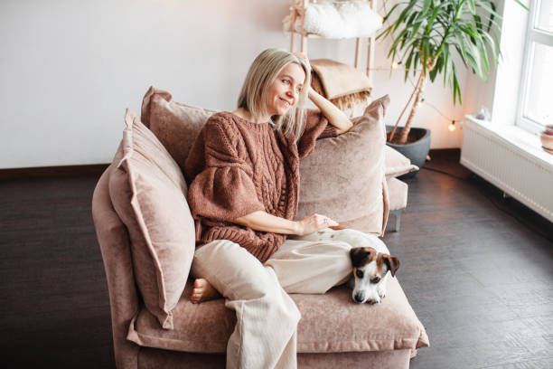 istock Cut Middle aged Woman sitting on couch at home 2174817972