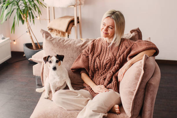 istock Cut Middle aged Woman sitting on couch at home 2174817974