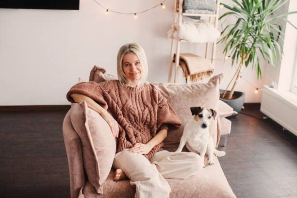 istock Cut Middle aged Woman sitting on couch at home 2174817977
