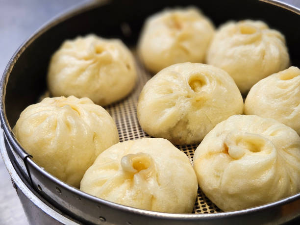 istock Traditional Chinese pork bun serving on the woven basket. 2174821970