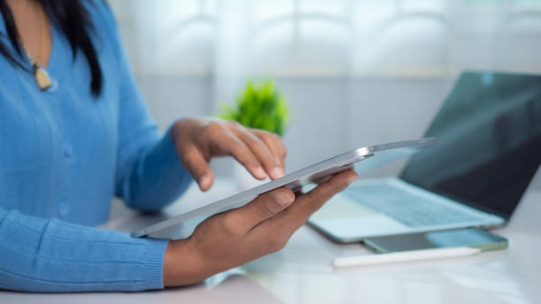 istock Businesswoman use devices manage finances, Analyze diagrams statistics in office, Close up back view of female accountant work on electronic gadgets prepare financial report on tablet and laptop. 2174825770