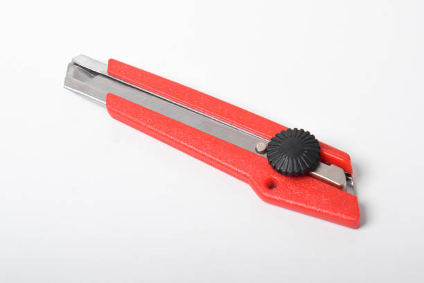 Red utility knife cutter isolated on white background. Stationery cutter knife