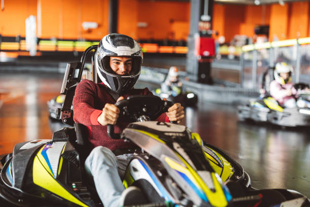istock Young Man Leading a Group in Indoor Go-Kart Race 2174833182