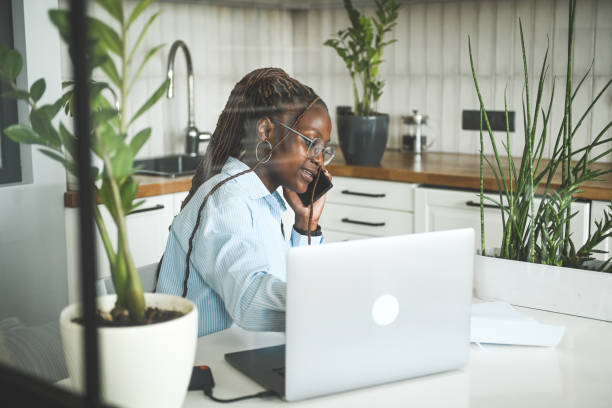 istock young woman using laptop and smartphone 2174838843