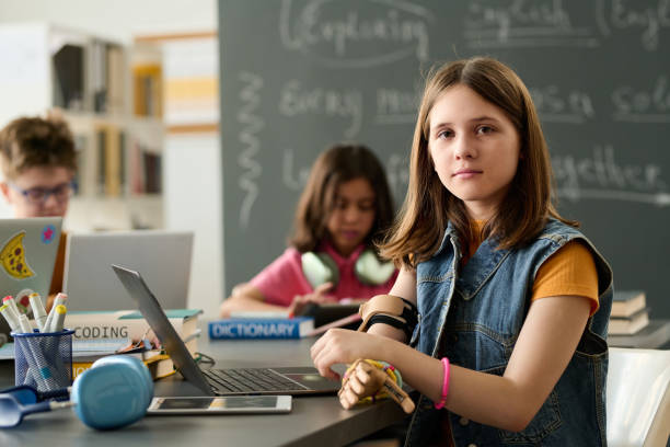 Teacher helping student in the computer room at school