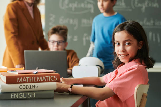 istock Schoolgirl Wearing Pink Looking at Camera 2174840038