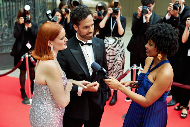 istock Entertainment correspondent interviewing celebrity couple 2174841711