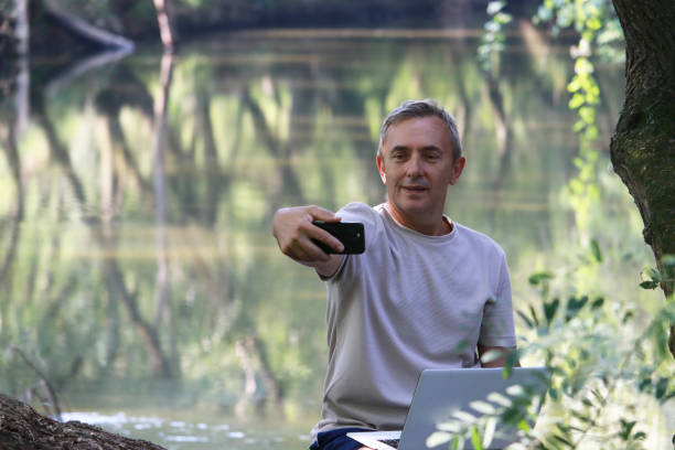 istock Mature man using technology for business in nature 2174842682