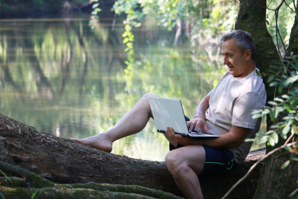 istock Mature man using technology for business in nature 2174842690