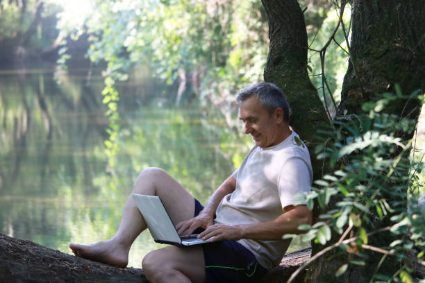 istock Mature man using technology for business in nature 2174842779
