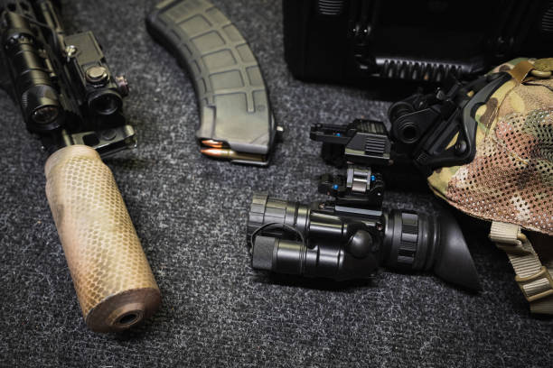 istock Tactical gear, rifle with silencer, flashlight, laser sight/IR, ammunition, magazine and night vision device. 2174843087