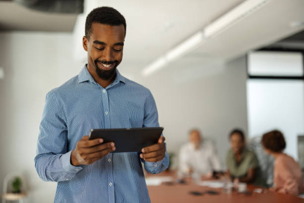 istock Man in checkered shirt engaged with digital tablet 2174843383