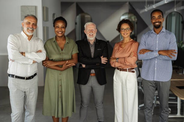 istock Professional team poses confidently in office space. 2174843951