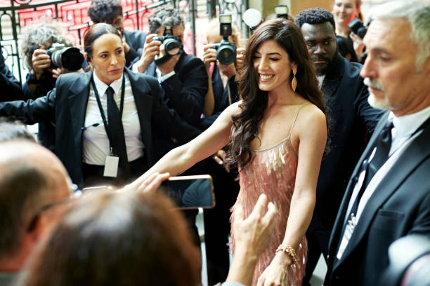 istock Security staff surrounding celebrity at red carpet event 2174844148