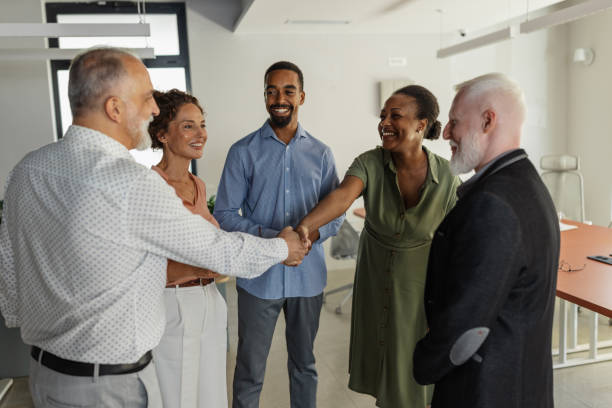 istock Office handshake celebration among cheerful colleagues. 2174844423