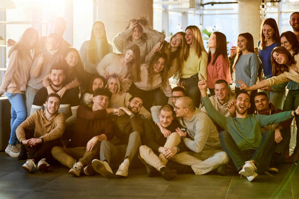istock Large group of happy students having fun in a school hallway. 2174844611