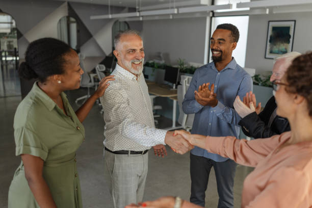 istock Colleagues shaking hands celebrating a successful deal. 2174844700