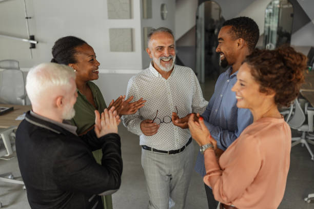 istock Smiling group of diverse colleagues in office meeting 2174844765
