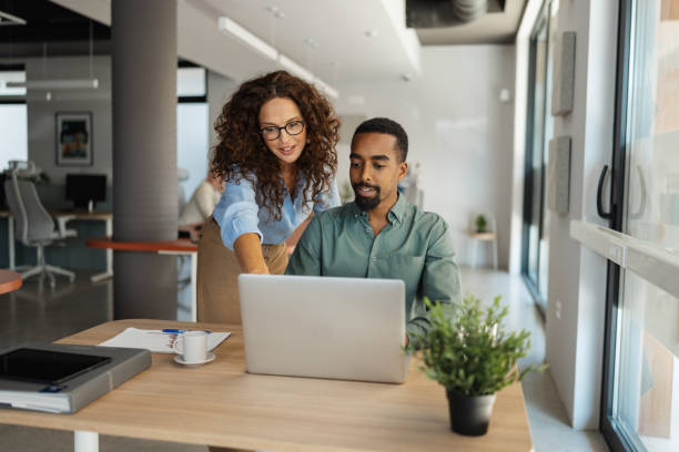 istock Colleagues collaborating on a project at a desk 2174845910