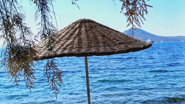 wicker sun umbrellas by the sea