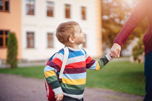 istock Mother takes her child to educational institution. 2174850737