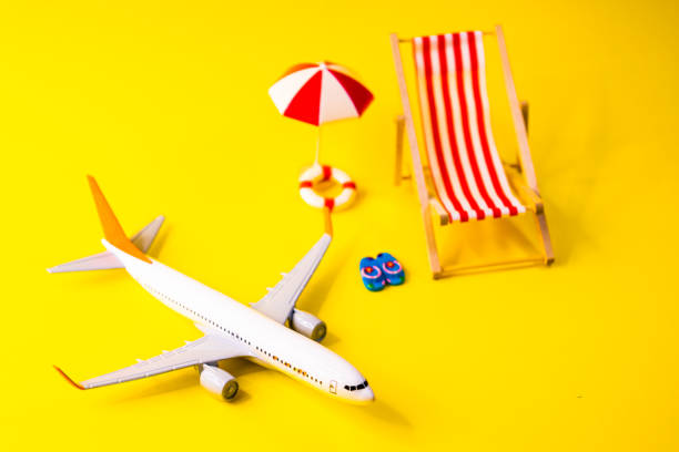 istock white miniature airplane on a yellow background next to a hammock 2174851912