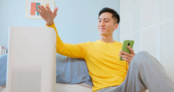 istock Asian male enjoy air purifier 2174852985