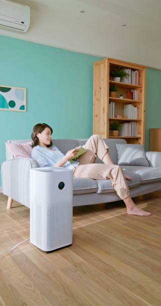 istock woman use air purifier home 2174854685