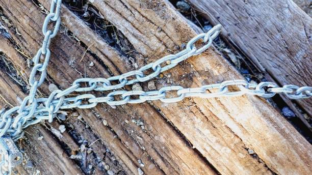 old log by the sea. Wood and chain.