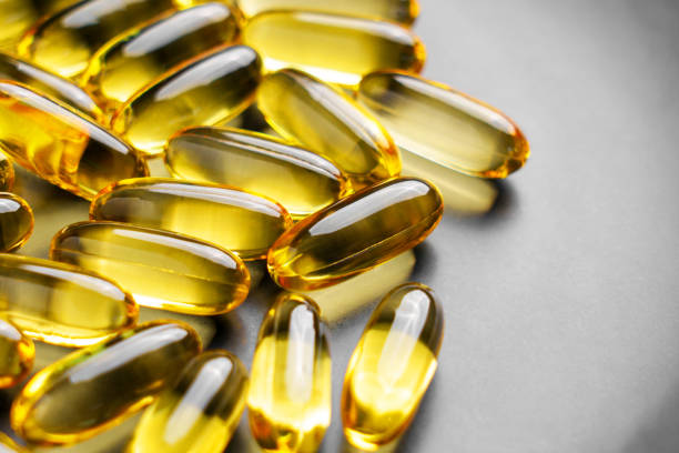 istock Omega 3 supplements in golden translucent natural softgel capsules 2174855270