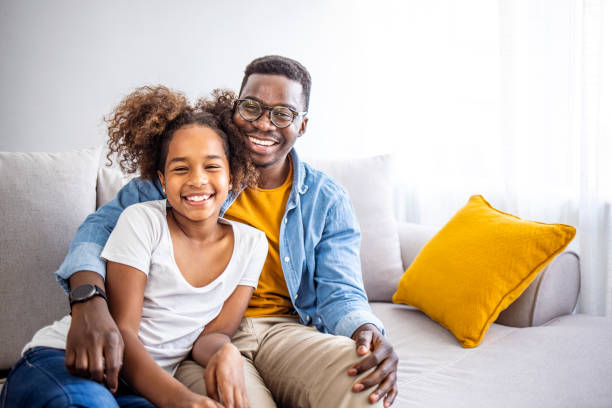 istock Happy Father and Daughter Relaxing on Comfortable Sofa at Home 2174859054