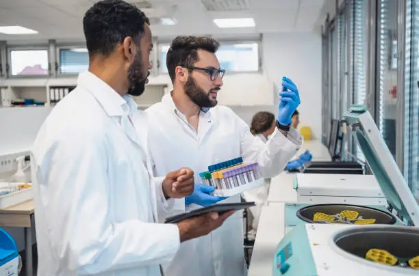 Photo of Diverse Lab Technicians Analyzing Samples