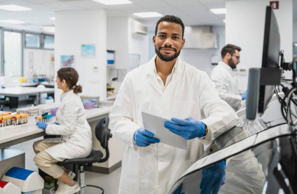 istock Diverse Male Scientist with Colleagues in Lab Setting 2174865874