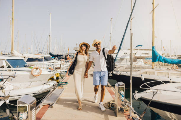 istock Happy Couple Strolling on a Sunny Marina Walkway 2174869947
