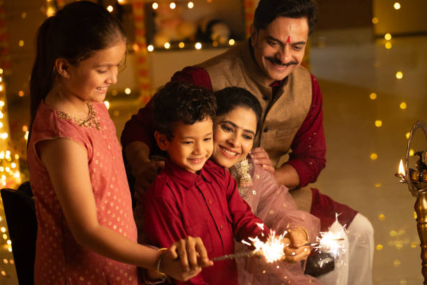 istock Parents with children burning sparklers at home during Diwali 2174872883