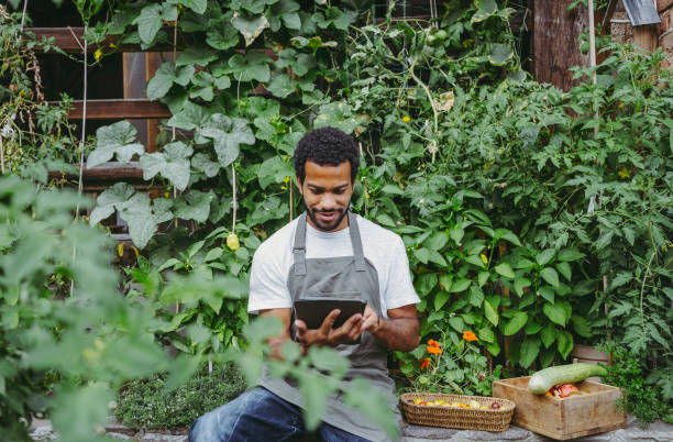 Gardener with Digital Tablet in Organic Garden Setting