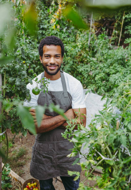 istock Smiling Diverse Gardener in Organic Garden 2174875011