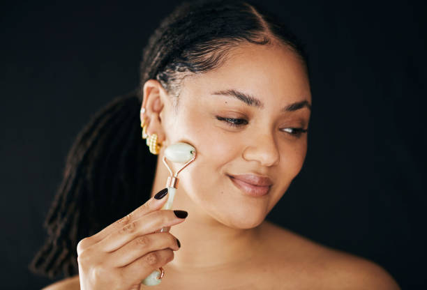 istock Happy Woman Using Facial Roller in Skincare Routine 2174876304