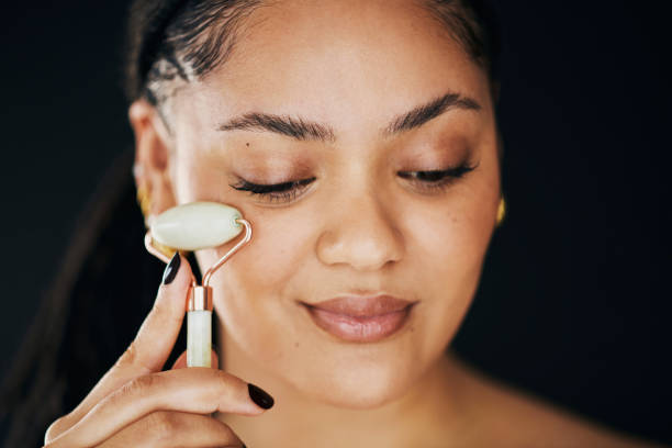 istock Happy Woman Using Facial Roller in Skincare Routine 2174876307