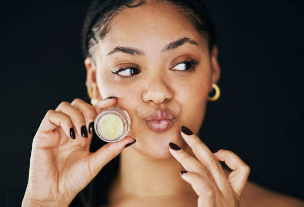 istock Happy Woman Applying Lip Balm in Skincare Routine 2174876322