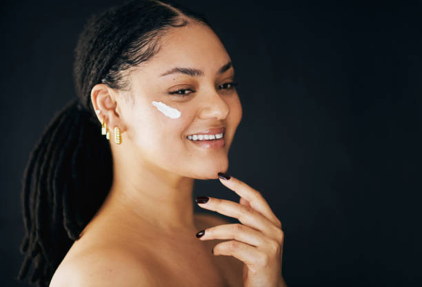 Happy Woman Applying Face Cream in Skincare Routine